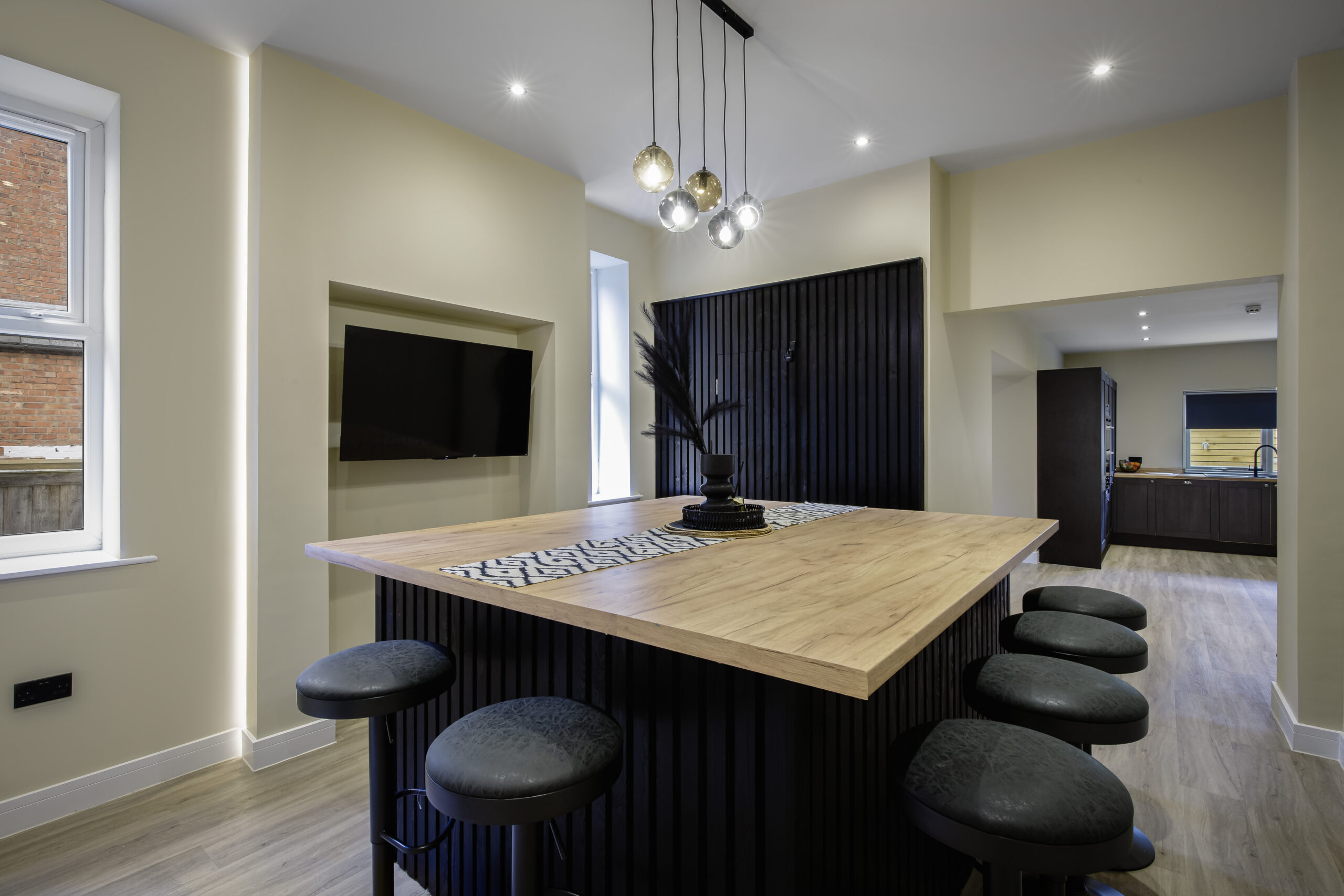 Kitchen at All Saints House with a wooden island and seating
